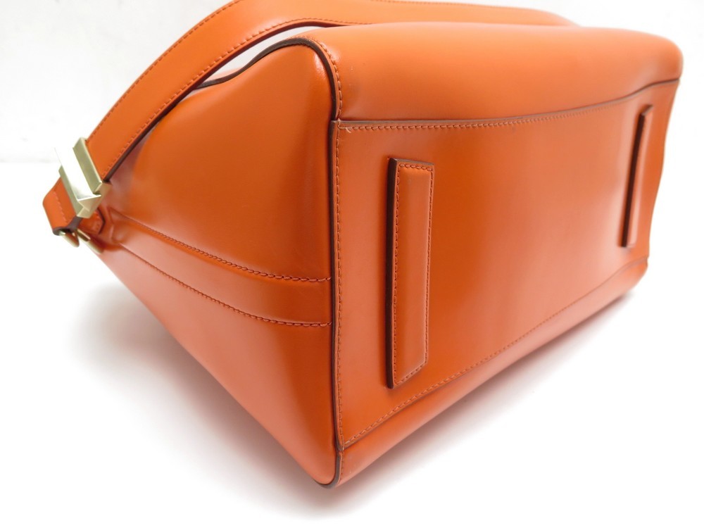 Givenchy Petit sac à main orange à cordon avec longs pompons Cuir